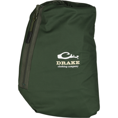 A close-up of the Tempest Ultralight Packable Rain Pant's green bag with a zipper, featuring a logo.