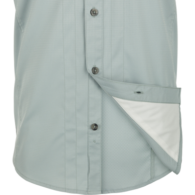 Close-up of Wingshooter Trey Solid Dobby Shirt S/S with hidden collar, chest pockets, and vented back, made of performance fabric for outdoor activities.
