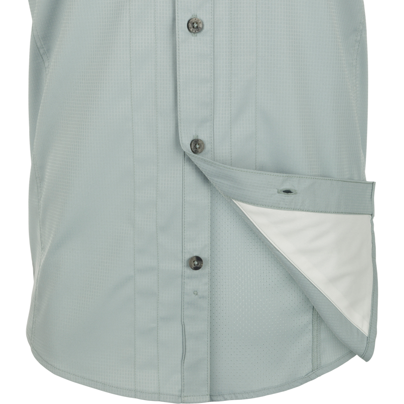 Close-up of Wingshooter Trey Solid Dobby Shirt S/S with hidden collar, chest pockets, and vented back, made of performance fabric for outdoor activities.