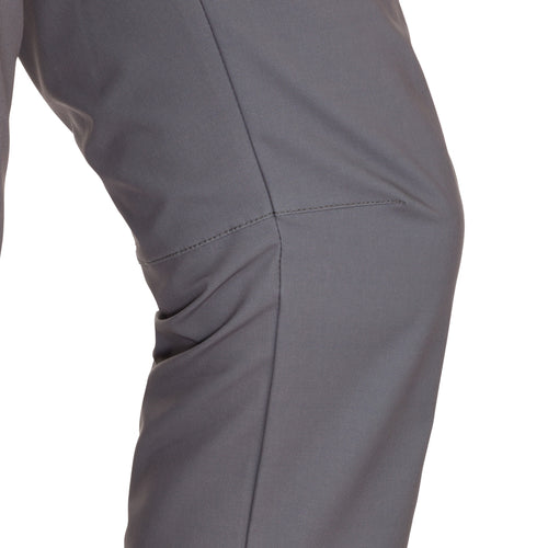 A close-up of the Traveler Trek Pant, a rugged and sophisticated garment from Drake Waterfowl. Made of 90% Polyester and 10% Spandex, it offers built-in stretch, moisture-wicking, and quick-drying properties. The pant features articulated knees, multiple pockets, and a YKK zippered cargo pocket. Perfect for your next adventure.