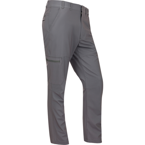A pair of lightweight, straight leg Traveler Trek Pants with built-in stretch and moisture-wicking fabric. Features include elastic side waist, front slash pockets, and hidden zippered back pockets. Perfect for your next adventure.
