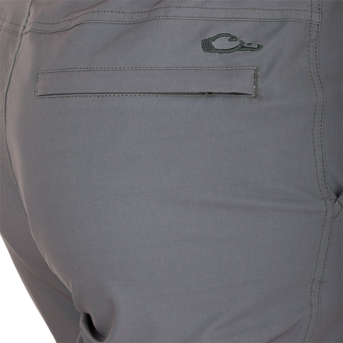 Close-up of a khaki pocket on the Traveler Trek Pant, featuring a black spiral and stitched detailing.