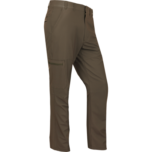 A pair of lightweight, quick-drying Traveler Trek Pants with built-in stretch for comfort. Features include articulated knees, multiple pockets, and a silicone grip waistband. Perfect for your next adventure.