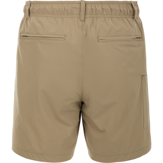 Dock Short 6" - A tan trouser with a zipper and stitched leather detail. Made from durable, quick-drying 90% Nylon/10% Spandex fabric. Features elastic waist, belt loops, and multiple mesh-lined pockets. Perfect for boat to dock transitions.