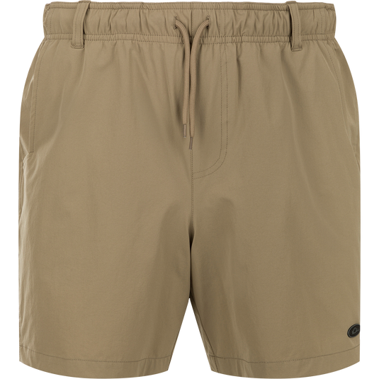 Dock Short 6" - A tan trouser made of durable nylon/spandex fabric. Features quick-drying, water-resistant finish. Elastic waist with drawstring and belt loops. Mesh-lined pockets and YKK zippered back pockets. Versatile for boat to dock transitions.