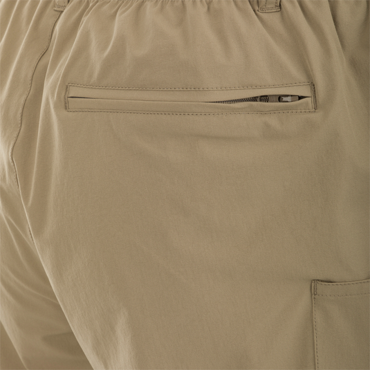 A close-up of the Dock Short 6" pocket on the Drake Men's Dock Short 6 Inch. Made with durable 90% Nylon/10% Spandex fabric, it features a water-resistant DWR finish. The pocket has a zipper and is perfect for holding pliers.
