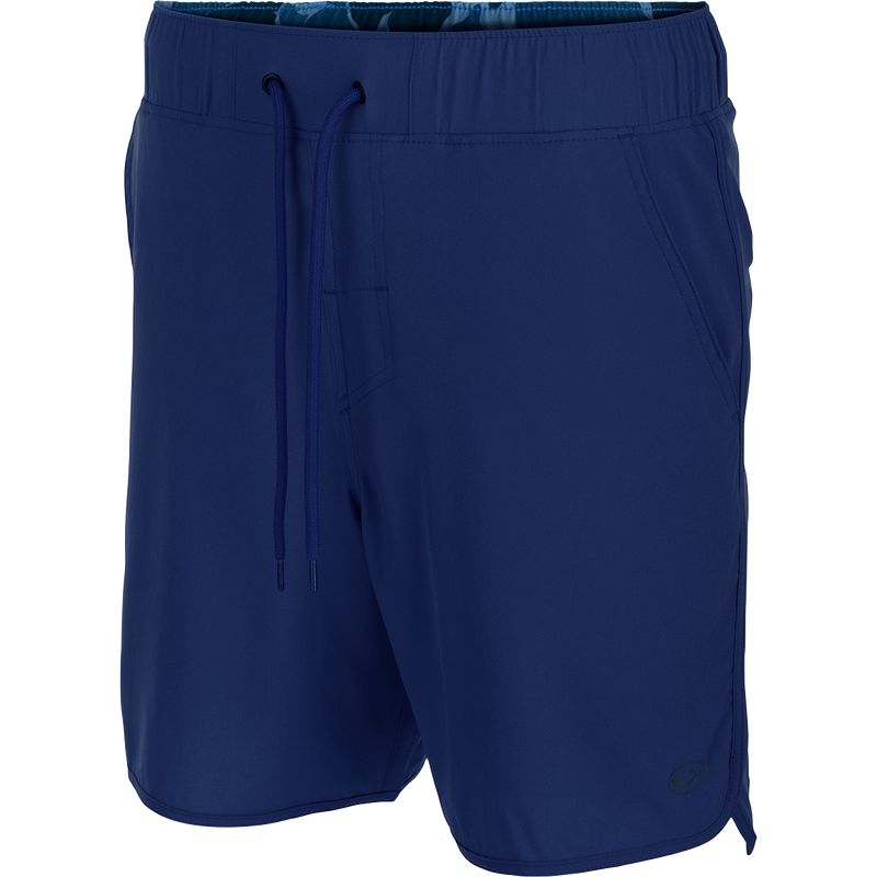 A versatile blue shorts with a drawstring, 4-way stretch, and a built-in liner. Features scalloped hem, back pockets with hidden zippers, front slash pockets, and a 7-inch inseam. Perfect for beach to bar.