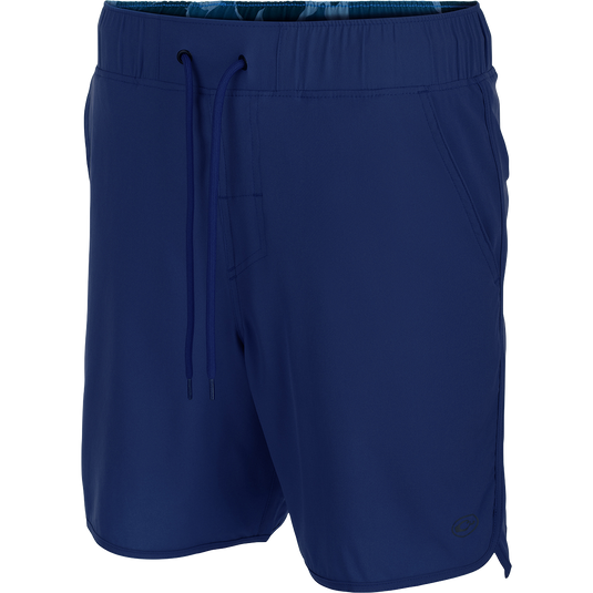 A versatile blue shorts with a drawstring, 4-way stretch, and a built-in liner. Features scalloped hem, back pockets with hidden zippers, front slash pockets, and a 7-inch inseam. Perfect for beach to bar.