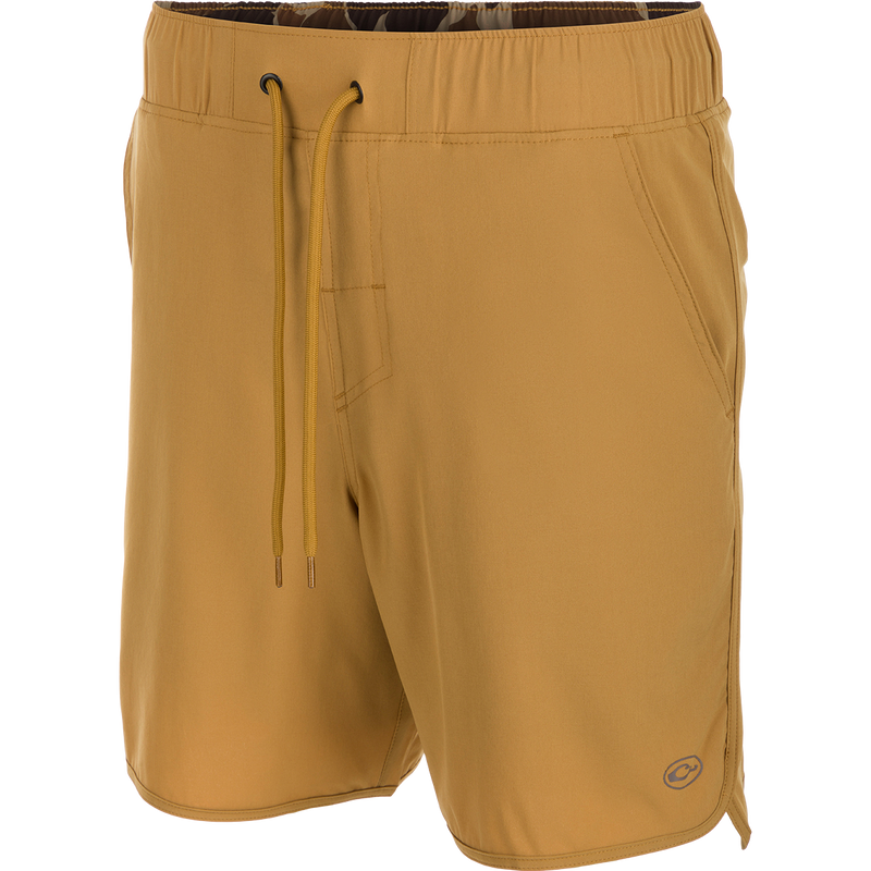 A pair of Commando Lined Volley Shorts with a drawstring, scalloped hem, and hidden zipper pockets. 7-inch inseam, 4-way stretch fabric, quick-drying, and moisture-wicking. Perfect for beach to bar transitions.