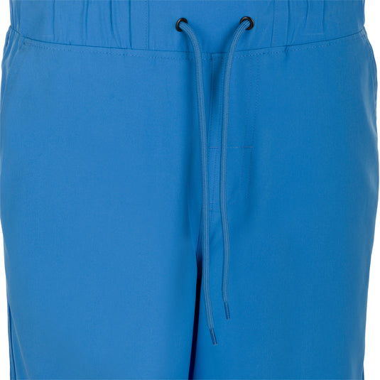 Commando Lined Volley Short 9" - A close-up of versatile blue shorts with clean lines, scalloped hem, and adjustable drawstring waistband. Features include quick-drying fabric, moisture-wicking liner, and multiple pockets. Perfect for beach to bar transitions.