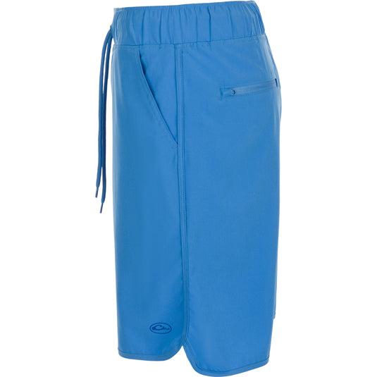 A versatile blue shorts with a drawstring and built-in liner, perfect for beach to bar transitions. Features include 4-way stretch, moisture-wicking, quick-drying fabric, and elastic waist with adjustable drawstring. Backed by Drake Waterfowl's high-quality hunting gear and clothing expertise.