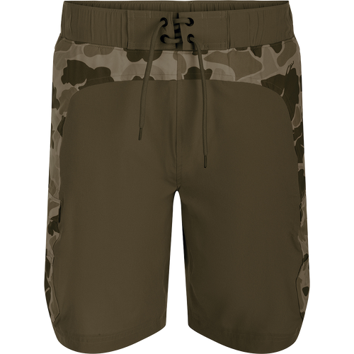 A pair of Commando Lined Board Shorts with camouflage print, cargo pockets, and a 9-inch inseam. Made of 88% polyester and 12% spandex for 4-way stretch. Quick-drying, moisture-wicking, and water-resistant. Features an elastic waistband with a drawstring for a perfect fit. Includes a built-in liner for added comfort. Perfect for beach or bar.