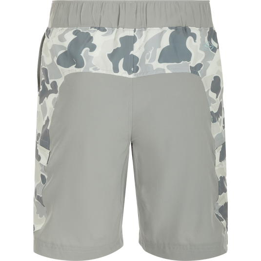 Commando Lined Board Short 9": A versatile pair of shorts with a camouflage pattern, 4-way stretch, quick-drying fabric, and built-in liner. Features cargo pockets, slash pockets, and an adjustable waistband. Perfect for beach to bar transitions.