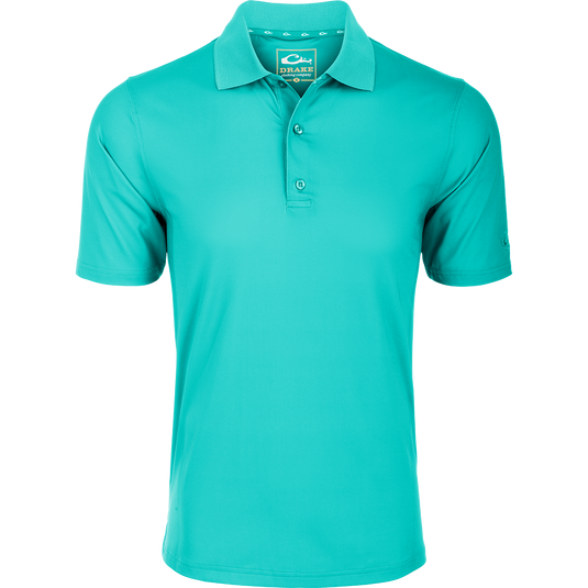 Performance Stretch Polo S/S: A close-up of a shirt with a logo on a green surface. Lightweight, moisture-wicking fabric with 4-way stretch for comfort. Open sleeves, rib knit collar, and split tail hem. Perfect for any occasion.