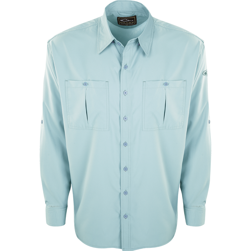 A light blue button-up Flyweight Shirt with vented back and horizontal chest pockets, made of ultra-lightweight polyester for warm-weather outdoor activities. Quick-drying, moisture-wicking, and breathable with Sol-Shield™ UPF 50+ sun protection.