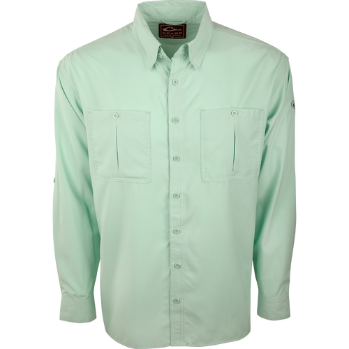 A close-up of the Flyweight Shirt with Vented Back L/S. A green button-up shirt made of ultra-lightweight polyester. Features include Sol-Shield™ UPF 50+ sun protection, vented mesh back, and horizontal chest pockets. Quick-drying, moisture-wicking, and breathable.