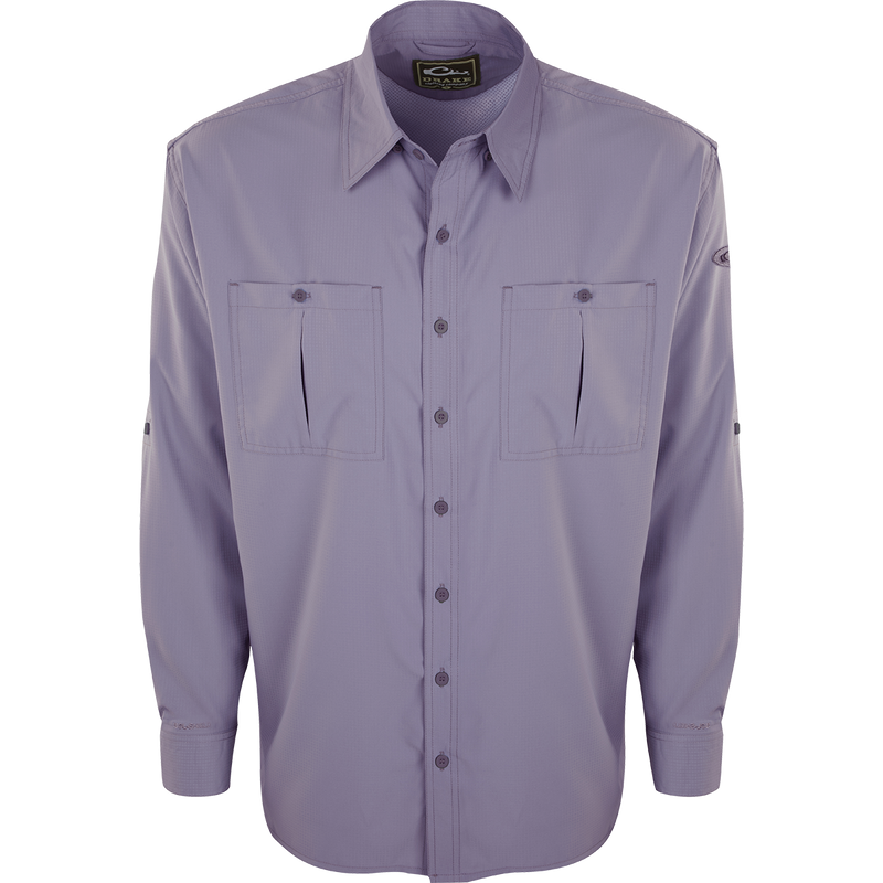 A close-up of the Flyweight Shirt with Vented Back L/S. A long-sleeved purple shirt featuring a logo and pocket. Lightweight, breathable, and quick-drying. Perfect for warm-weather outdoor activities.