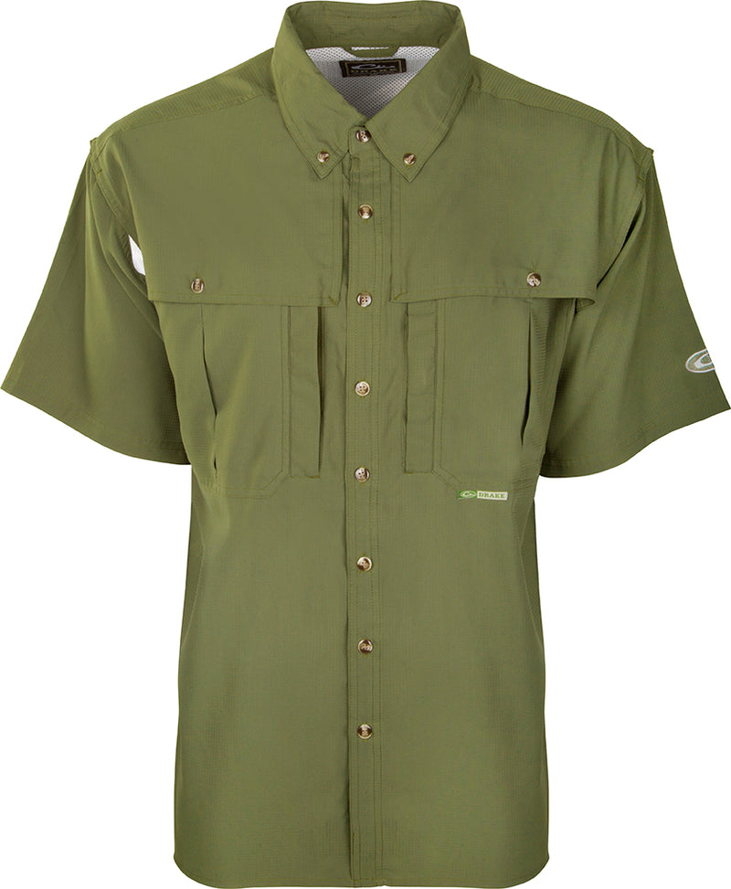 A close-up of the Youth S/S Flyweight Wingshooter's Shirt, a green shirt with buttons. Lightweight, quick-drying fabric perfect for active kids. Comfortable and stylish for school, play, and in the field.