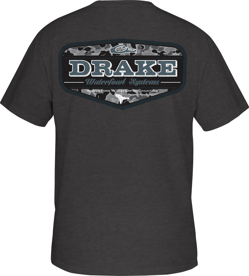 A black shirt with a logo from the Old School Camo Series, featuring a Drake logo on the front pocket. Lightweight and comfortable.