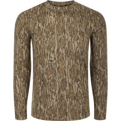 A long sleeved shirt with a tree pattern, designed for optimum comfort and durability. Made of 92% Polyester/8% Spandex with 4-Way Stretch for flexibility. Features Shield 4 Sun™ UPF 50+, Shield 4 Coolant™, Shield 4 Odor™, and Shield 4 Stains™ treatments for sun protection, heat resistance, odor control, and stain resistance. From Drake Waterfowl, a store specializing in high-quality hunting gear and clothing.