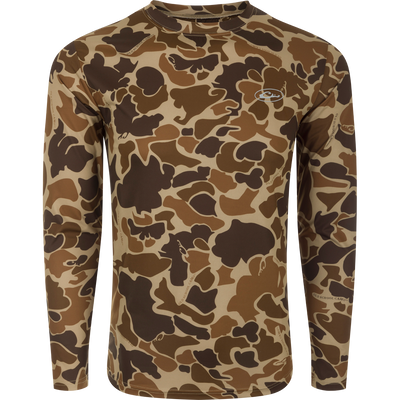 A long-sleeved shirt with a camouflage pattern, designed for optimum comfort and durability. Made with 92% Polyester/8% Spandex and 4-Way Stretch for superior flexibility and protection. Features Shield 4 Sun™ UPF 50+, Shield 4 Coolant™, Shield 4 Odor™, and Shield 4 Stains™ treatments for effective sun, heat, odor, and stain protection. Perfect for big game hunting, waterfowl hunting, turkey hunting, and fishing.