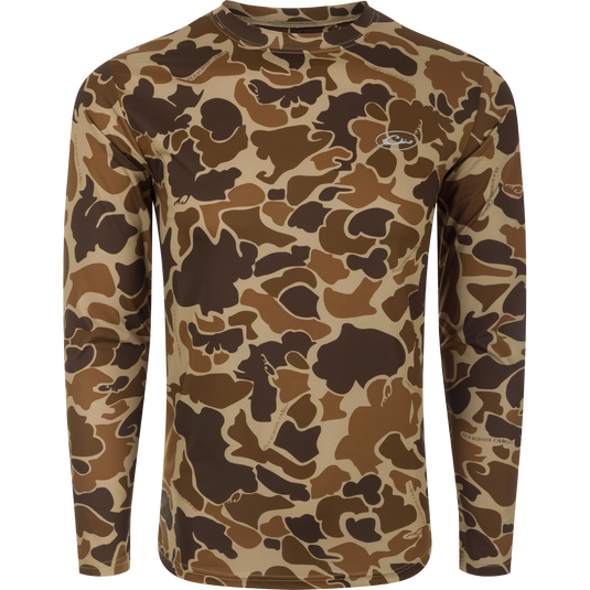 A long-sleeved shirt with a camouflage pattern, designed for optimum comfort and durability. Made with 92% Polyester/8% Spandex and 4-Way Stretch for superior flexibility and protection. Features Shield 4 Sun™ UPF 50+, Shield 4 Coolant™, Shield 4 Odor™, and Shield 4 Stains™ treatments for effective sun, heat, odor, and stain protection. Perfect for big game hunting, waterfowl hunting, turkey hunting, and fishing.
