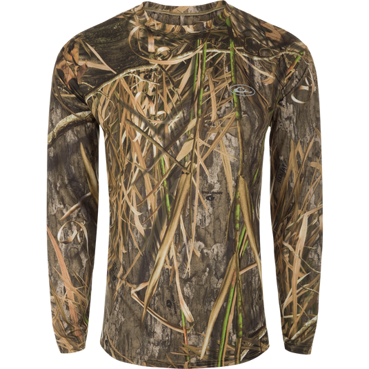 A long sleeved shirt with a camouflage pattern, designed for optimum comfort and durability. Made of 92% Polyester/8% Spandex with 4-Way Stretch for flexibility and protection. Features Shield 4 Sun™ UPF 50+, Shield 4 Coolant™, Shield 4 Odor™, and Shield 4 Stains™ treatments for effective sun, heat, odor, and stain protection. EST Camo Performance Crew L/S from Drake Waterfowl.