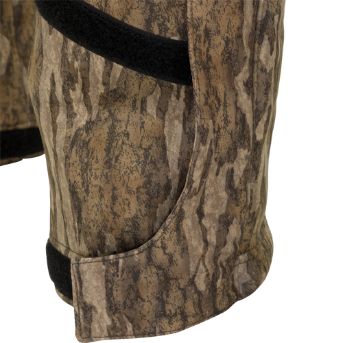 MST Ultimate Wader Bib: Close-up of camouflage shorts with black band, Sherpa-lined pockets, and zippered rear security pockets.
