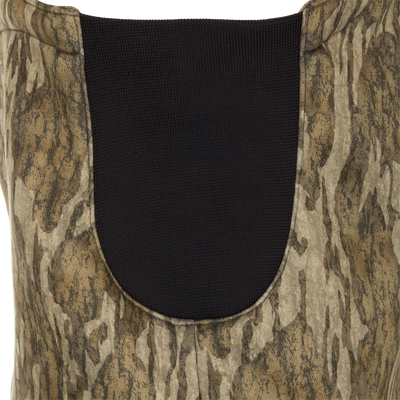 A close-up of the MST Ultimate Wader Bib, featuring a vest with Sherpa-lined handwarmer pockets, a Magnattach™ chest pocket, and zippered rear security pockets. The 100% polyester fleece shell and Sherpa fleece lining provide comfort and performance.