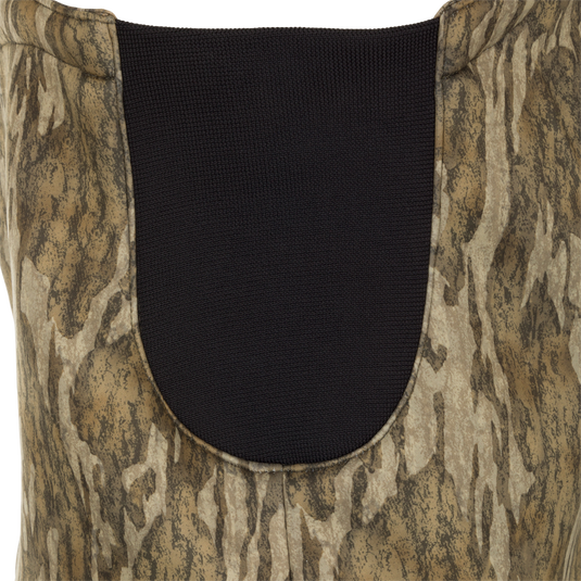 A close-up of the MST Ultimate Wader Bib, featuring a vest with Sherpa-lined handwarmer pockets, a Magnattach™ chest pocket, and zippered rear security pockets. The 100% polyester fleece shell and Sherpa fleece lining provide comfort and performance.