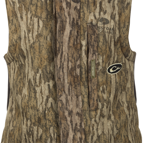 MST Ultimate Wader Bib: A camouflage vest with Sherpa-lined pockets and zippered security pockets for storage. Four-way stretch material and articulated knees for easy movement.