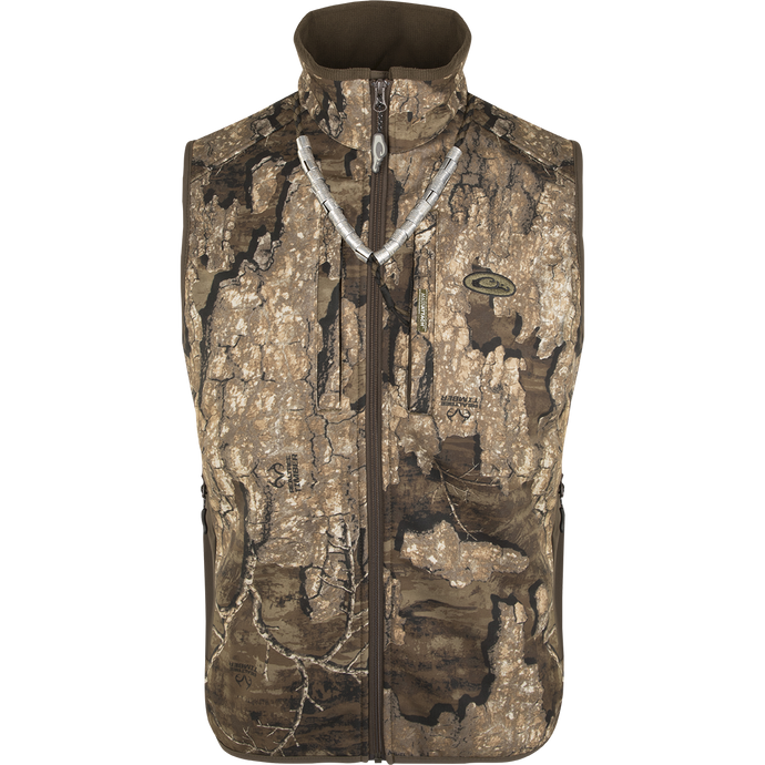A close-up of the EST Camo Windproof Tech Vest, featuring a tree pattern and a zipper. This vest stops biting winds, providing comfort and warmth during hunting.