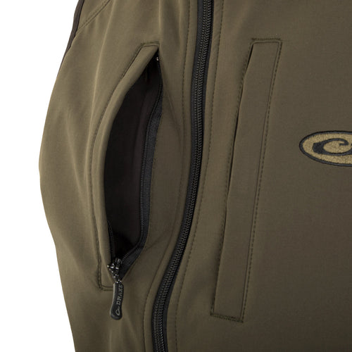 A close-up of the EST Windproof Tech Vest, showcasing its khaki fabric and zippered pockets.