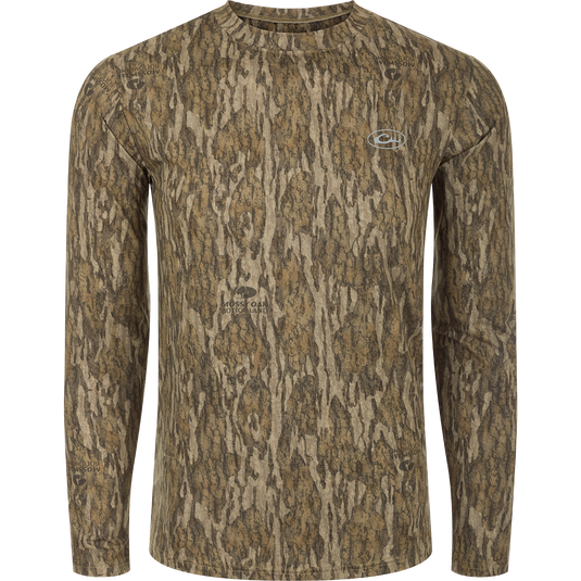 A Youth EST Camo Performance Long Sleeve Crew shirt with a tree pattern, offering comfort and protection with 4-Way Stretch and Shield 4 treatments.