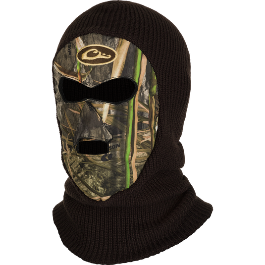A black face mask with a camouflage design, providing full coverage and protection in bitter cold weather. Tailored eye and mouth openings for unrestricted visibility, breathability, and calling. Made from warm poly-knit fabric with superior stretch capabilities for a comfortable fit.