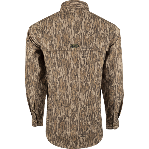 A lightweight, long-sleeved shirt with a tree pattern. Designed for breathability during hunts or at the shooting range. Features vents, mesh, and button tabs on sleeves. From Drake Waterfowl.