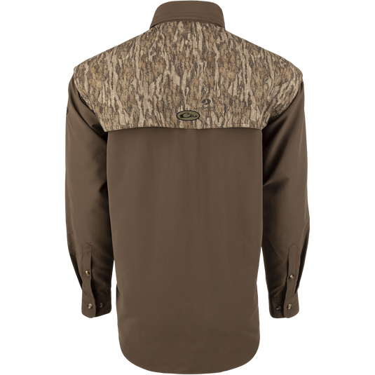 A lightweight, breathable Wingshooter's Shirt with a camouflage design. Features vents, mesh lining, and button tabs on sleeves for comfort and style. Perfect for hunting and shooting activities.