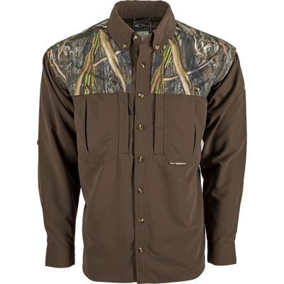 A lightweight, breathable Wingshooter's Shirt with a camouflage design. Features vents, mesh, and button tabs on sleeves for comfort and style. Perfect for hunting and shooting activities.