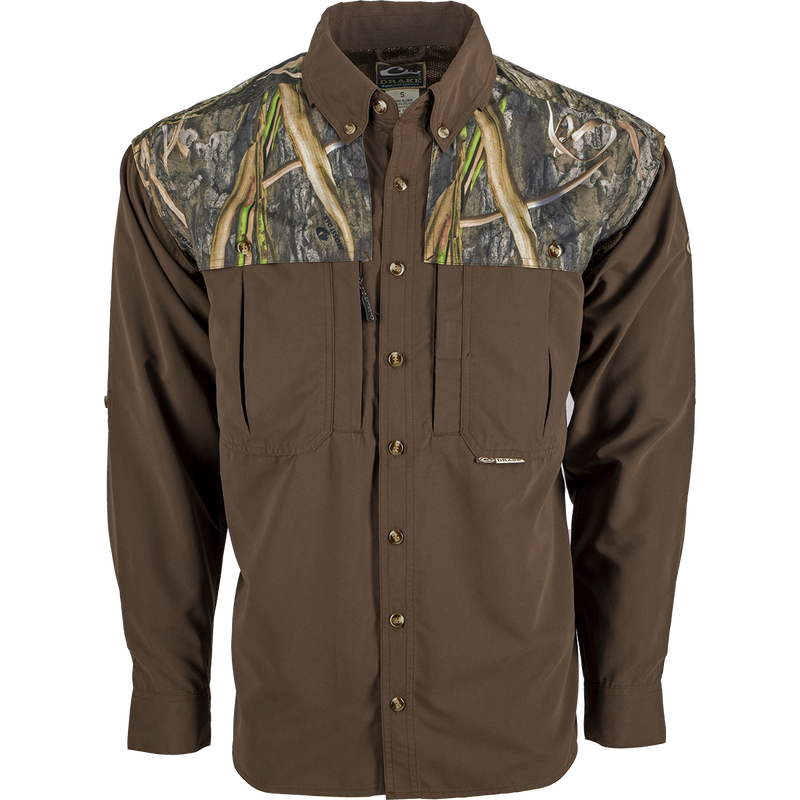 A lightweight, breathable Wingshooter's Shirt with a camouflage design. Features vents, mesh, and button tabs on sleeves for comfort and style. Perfect for hunting and shooting activities.