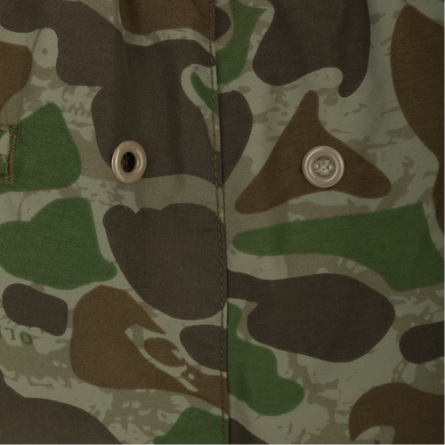 Camo Dock Shorts - Old School Green: Close-up of a camouflage jacket with button and fabric details.
