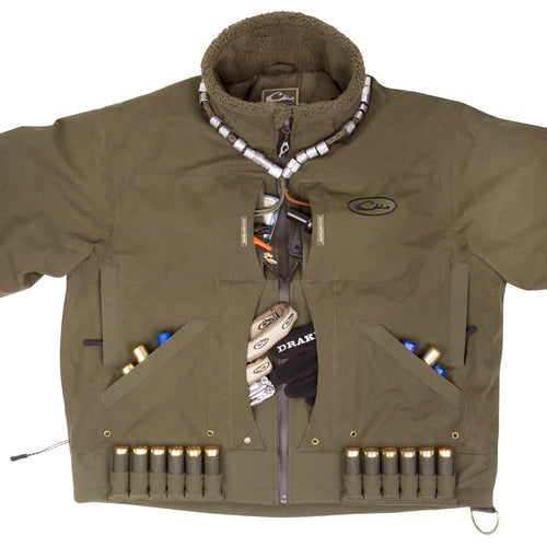 A waterproof Guardian Elite™ Flooded Timber Jacket - Shell Weight with multiple pockets and adjustable features for the avid hunter.