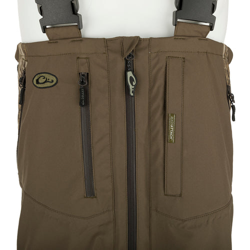 A brown vest with black straps, a brown bag with zippers, and a close-up of a black belt on the EST Guardian Elite Pro Ultralight 3-Layer Bibs.