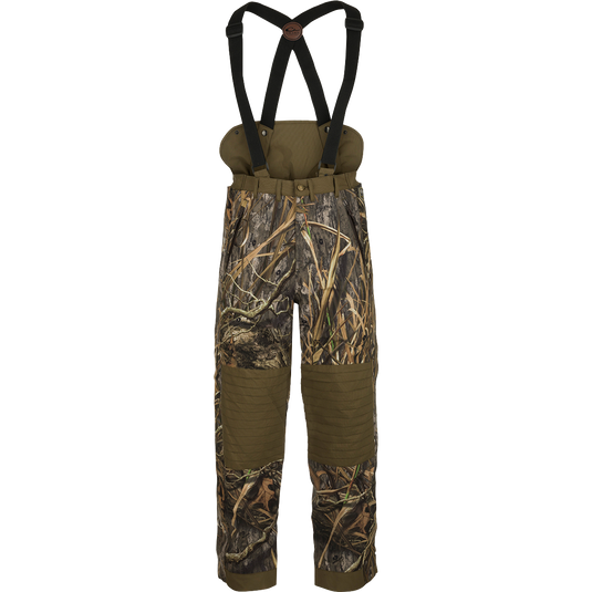 LST Guardian Elite High-Back Insulated Hunt Pant: Camouflage overalls with straps, designed to retain body heat below the waist. Waterproof, windproof, and breathable fabric with reinforced knees and seat. Removable suspenders and easy on/off side leg zippers.