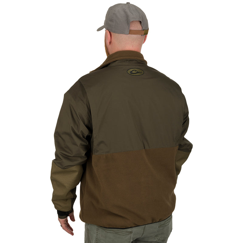 A man wearing the MST Guardian Eqwader Flex Fleece Full Zip Jacket, a waterproof/windproof/breathable shell jacket with 350-gram fleece lower body for enhanced breathability under waders.
