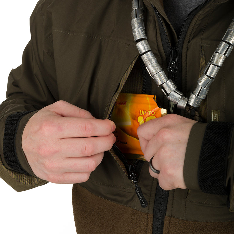 A person opening the MST Guardian Eqwader Flex Fleece Full Zip Jacket, showcasing its pocket.