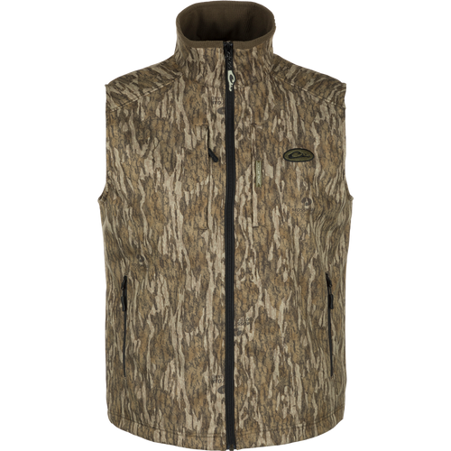 MST Windproof Softshell Vest with camouflage pattern, Magnattach™ chest pocket, and zippered pockets for secure storage. Customizable fit with drawcord waist. Superior comfort and breathability with 4-way stretch and grid-fleece collar lining. Expert-level functionality for hunting and outdoor activities.