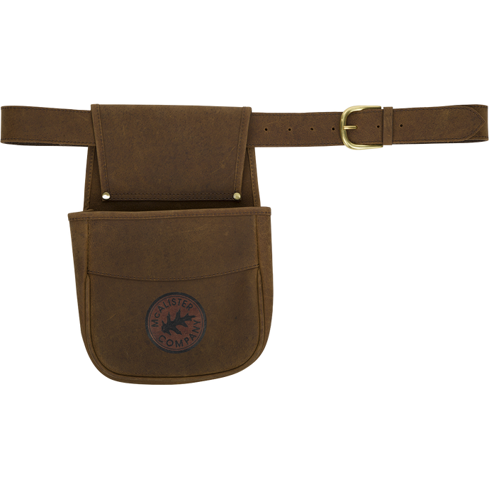 A brown leather belt pouch with a logo, perfect for carrying ammunition or empty shell cases. Made with top-grain water buffalo leather, brass hardware, and an adjustable leather belt. Durable and stylish.