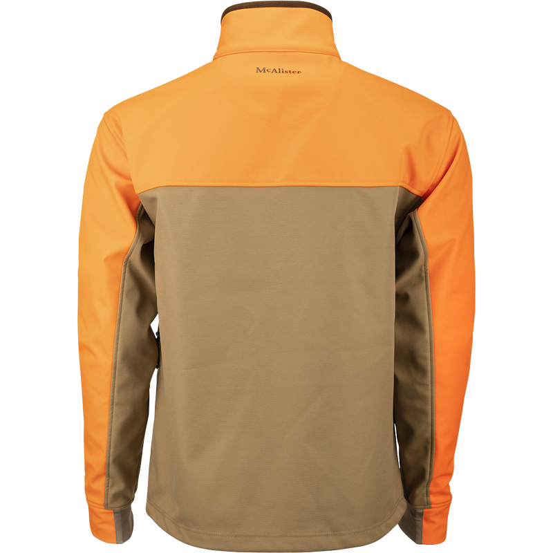 McAlister Upland Tech Softshell: A jacket with orange and tan sleeves, zippered pockets, underarm vents, and a drawcord waist. 100% Polyester.