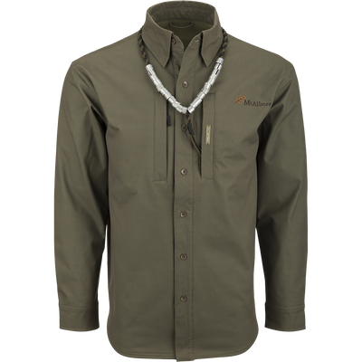 McAlister Microfleece Softshell Waterfowler's Shirt: A green long-sleeved shirt with a necklace, perfect for fluctuating weather conditions. Features include windproof softshell fabric, ample pocket storage, and comfortable range of motion.