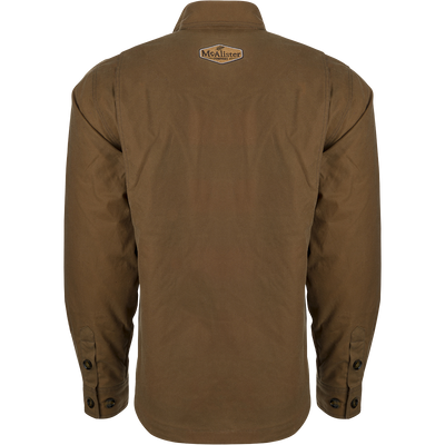 McAlister Waxed Cotton Jac-Shirt, a brown jacket with a white logo on it. Water and wind-resistant, with a heritage look and functional fit. Fleece-lined hand pockets.